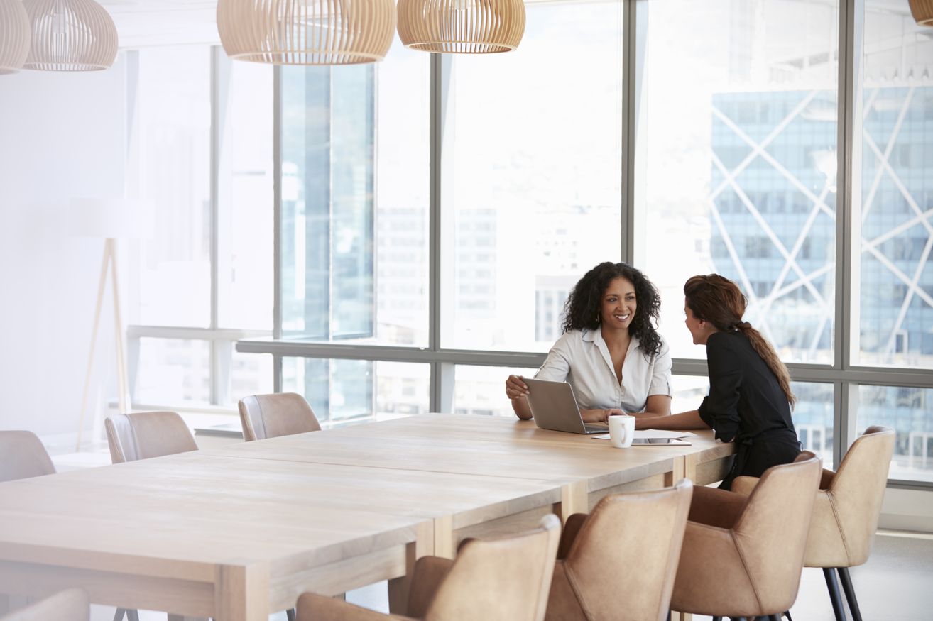 Two colleagues having a productive workplace conversation